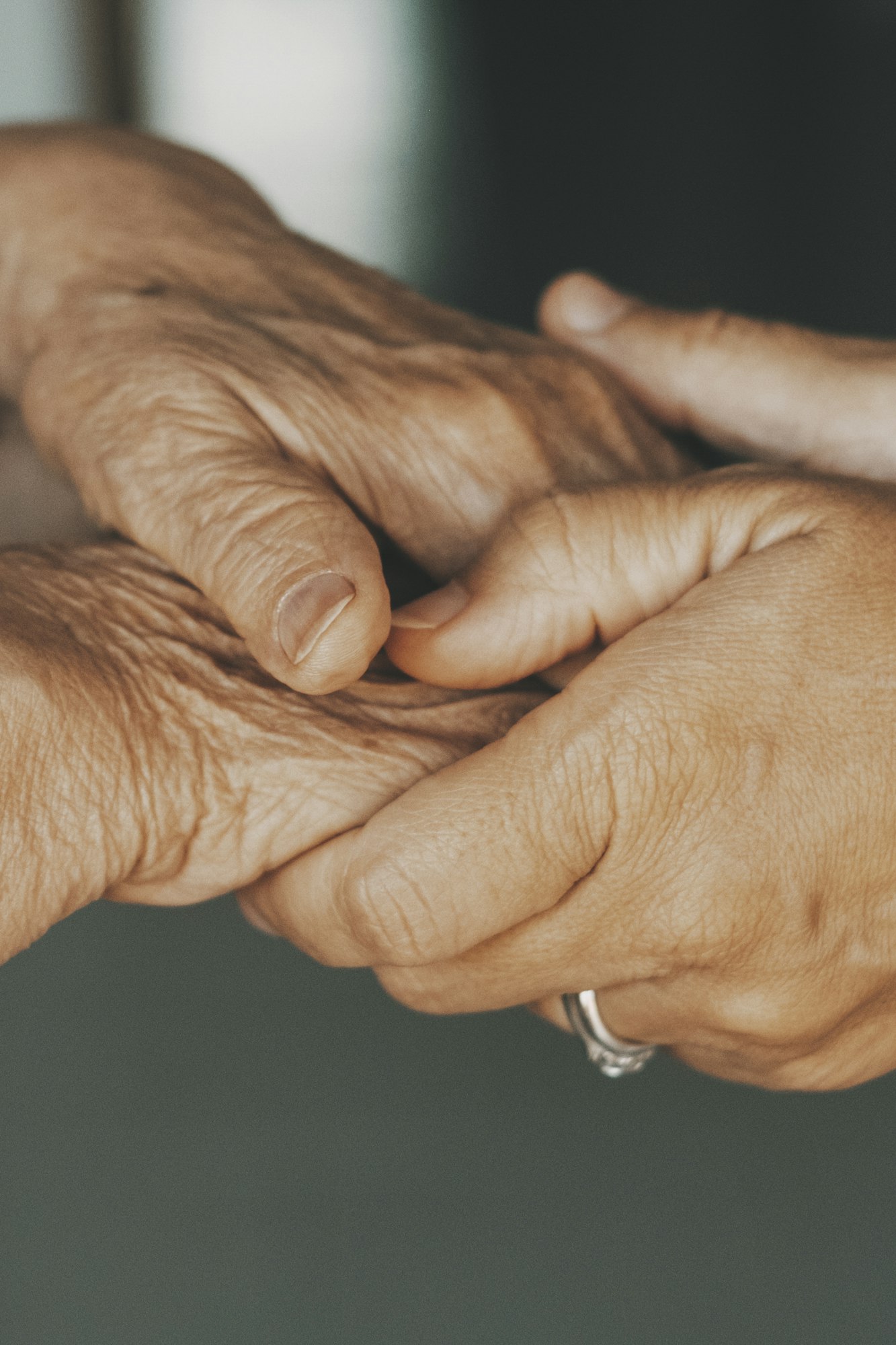 Close up older spouses holding hands with love and care, loving caring mature man