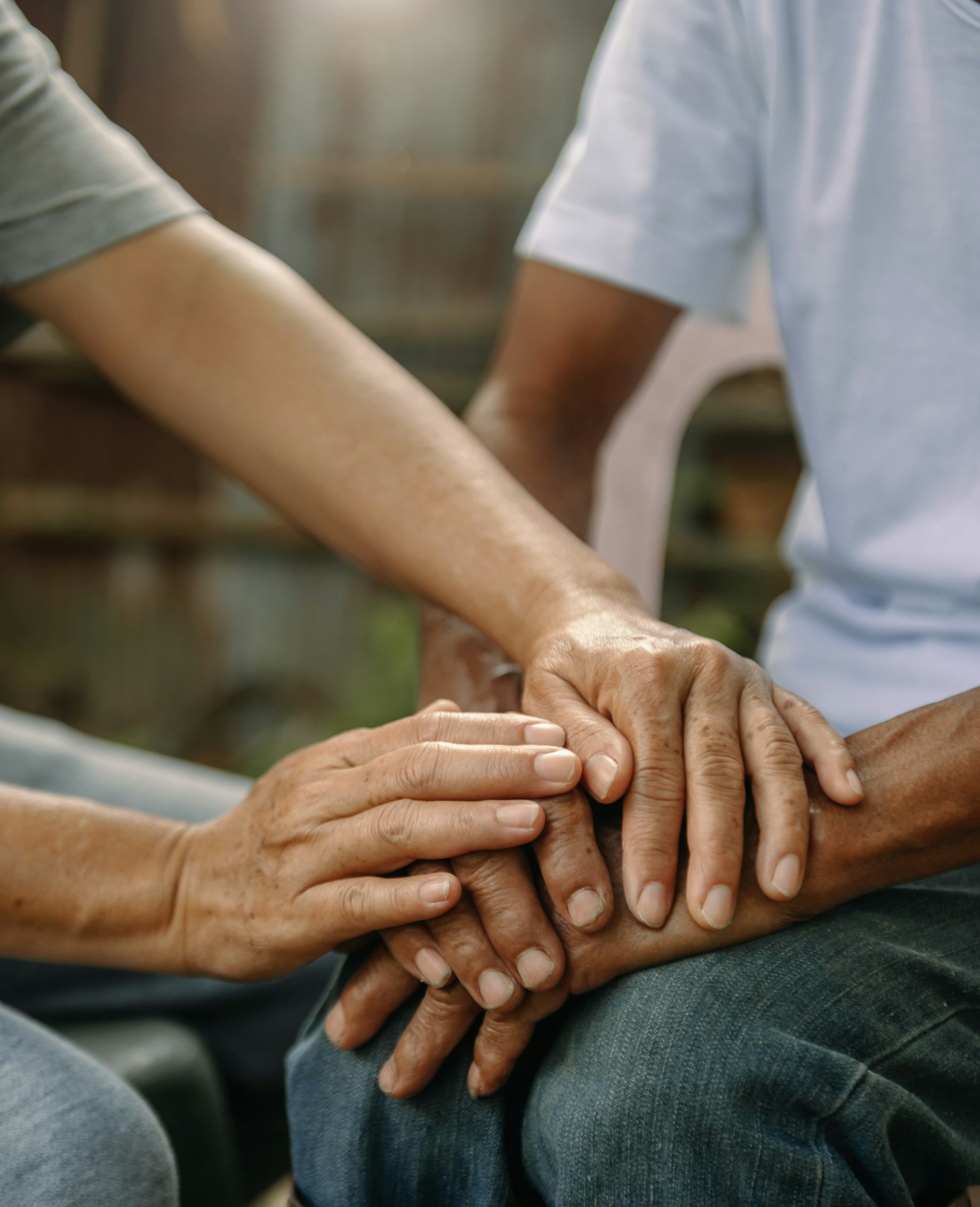 Hands of the old man and a woman hand